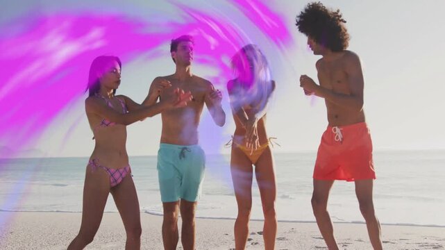 Clip starting, 4 adults clapping and stepping synced on sand, magenta ribbon wrapping group for ads