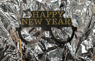 Festive Happy New Year glasses on a silver background, perfect for holiday greetings and celebration © vegefox.com