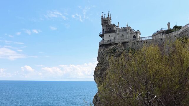 Swallow's nest castle is a famous architectural landmark. A neo-gothic structure defying gravity on aurora cliff. Offering breathtaking panoramic views of the tranquil black sea under a clear blue sky