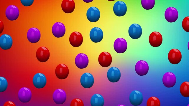Colorful round buttons or tablets falling through a vibrant blurred rainbow gradient background. Abstract motion graphics featuring red, blue, and purple glossy shapes for creative video content and b