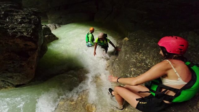 Travelers navigate upstream during canyoneering adventure at Kawasan Falls