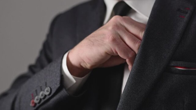 Businessman putting hundred euros banknote into inner pocket of his suit, symbolizing money, secrecy, corruption, illegal income, and unethical business behavior. 4K.