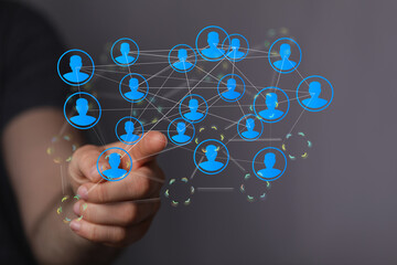 Fototapeta premium Concept of connection, community, and social networking with hand pointing at network diagram.