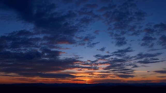 The captivating beauty of a dramatic sky at dusk, painted with vibrant hues of orange, yellow, and blue, as clouds drift across the horizon