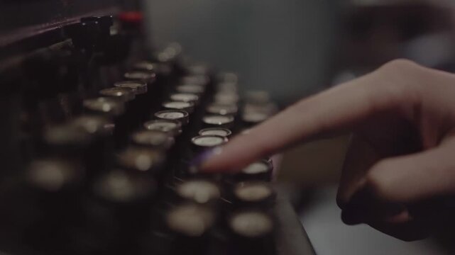 Detailed shot showing human hand pressing individual letter keys antique mechanical typewriter. Focus on keyboard action during composition or transcription. Ambience suggests nostalgic or historic th