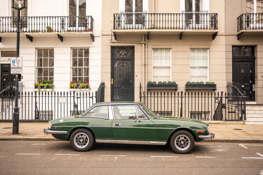 LONDON - MAY 12, 2026: BELGRAVIA - Classic green vintage car parked luxury residential street