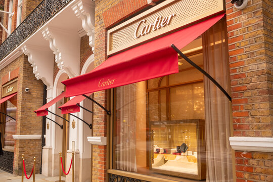LONDON - SLOANE STREET SW1X - Cartier luxury jewelry store full facade red awnings