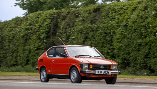 Bicester,Oxon.,UK - Apr 26th 2026: 1979 red Suzuki SC100 car driving on a British road