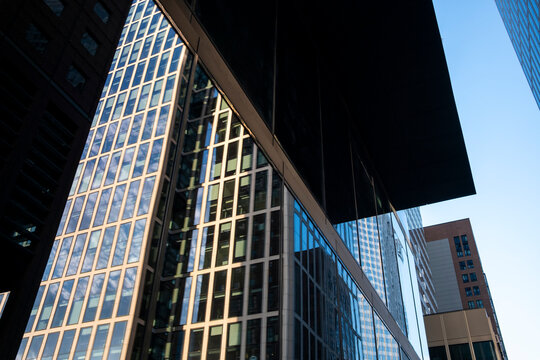 Glass skyscraper architecture office facade reflection street modern Bankenviertel Frankfurt with urban finance district and strong perspective