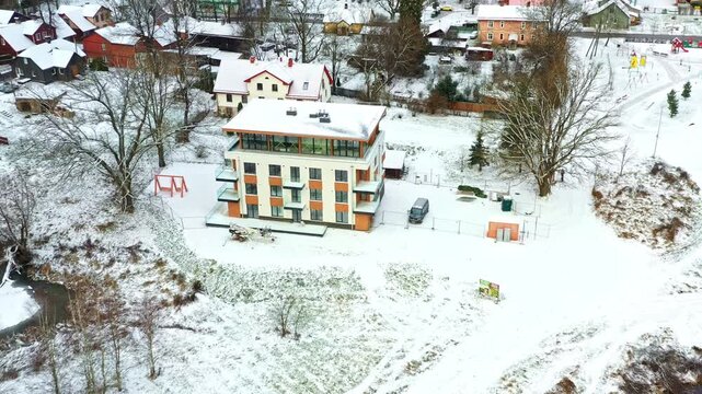 Modern apartment building offering housing in a snow-covered winter environment