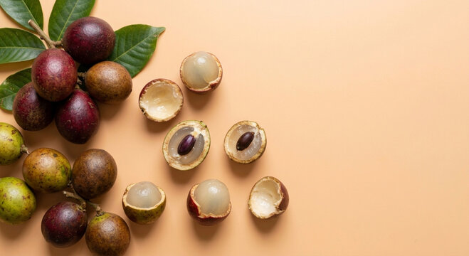 Top view of Matoa fruit or Pometia pinnata with whole and peeled pieces on beige background