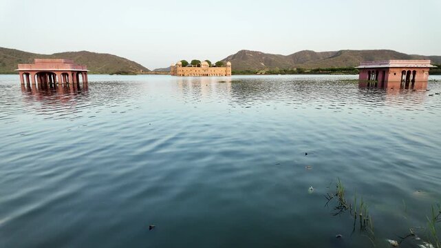 Three historic structures emerge from the calm waters of Man Sagar Lake.