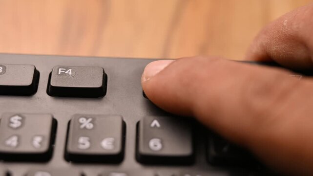 Keyboard Close Up of Man Using F5 Key for Web Page Reload Shortcut