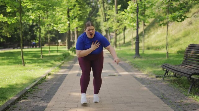 Young plus-size woman jogging in park, feeling sudden chest pain, muscle spasm