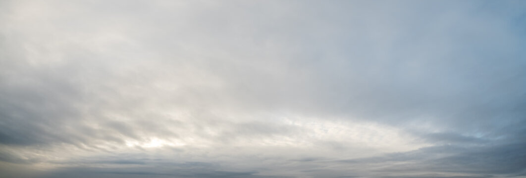 Clouds in the overcast evening sky view.