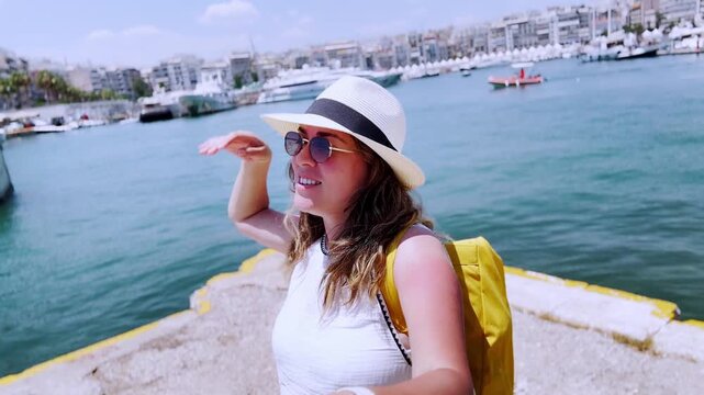 Young female vlogger exploring piraeus harbor in athens