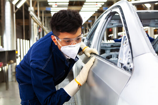  workers manufacture cars on an assembly line.