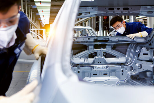  workers manufacture cars on an assembly line.