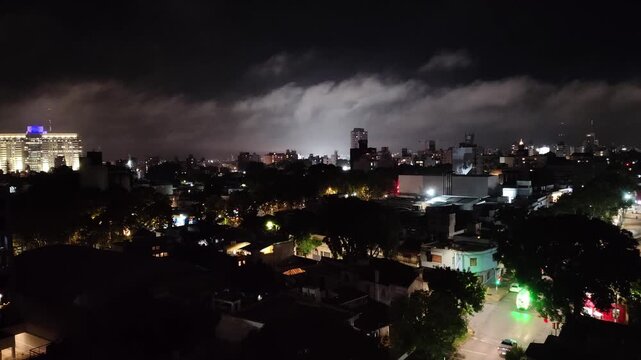 High contrast aerial view wide shot static video of montevideo city at night with overcast sky