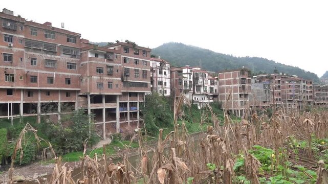 The legacy of the tradition of pile settlements. Apartment buildings on stilts right near the water's edge on the river. China. Xining