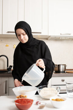 woman pouring water into bowl for rice