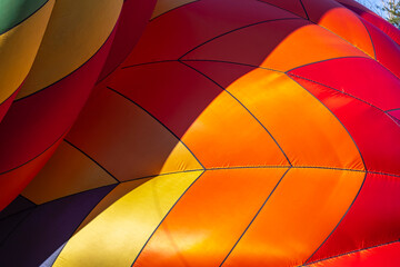 Fototapeta premium Colorful Hot Air Balloons Rise Into a Bright Blue Sky at a Joyful Local Festival
