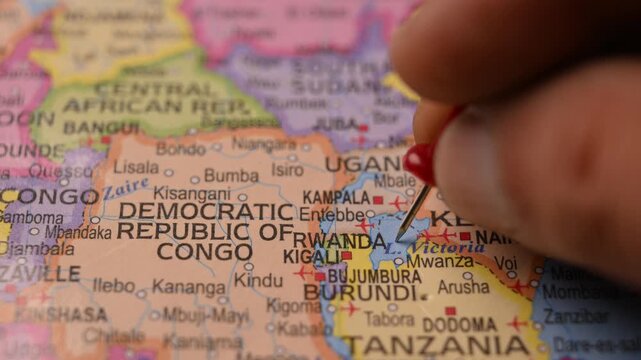 Hand Pointing Rwanda with Red Pin on World Map 4K 60fps