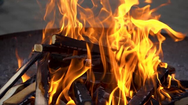 Slow motion of intense fire flames burning wood in a fire pit. Recorded in AppleProRes 422 for maximum editing flexibility.