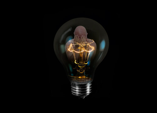 A genie is inside a lightbulb, waiting to come out.