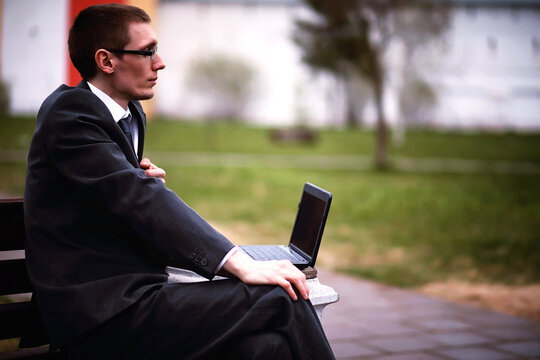 A man in a suit lies on a brick floor