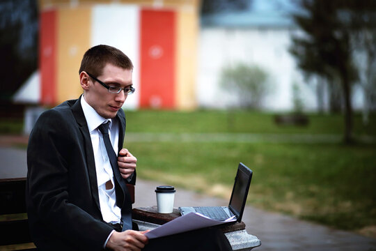 A man in a suit lies on a brick floor