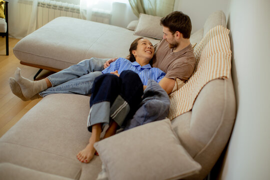 Couples relaxing together on a couch in cozy room during a quiet afternoon