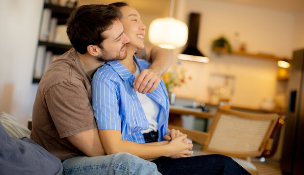 Korean woman and Caucasian man enjoying time together in cozy home setting