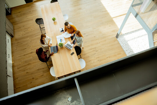 Group meets in a modern office space for a work session during the day