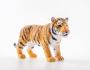 Obraz premium A realistic tiger figurine standing against a white background, capturing the majesty and ferocity of the animal in detail