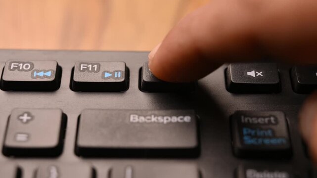 Close Up Keyboard Action of Man Using F12 Key to Access Developer Tools on Computer