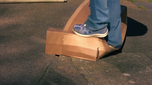 Jumping on cardboard box to squash