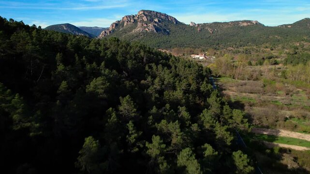 Aerial reveal shot of Las Caderechas Valley in Burgos Spain. Forest hills, mountains and rural scenery in a famous natural area. Ideal for tourism, travel, nature and destination projects. High