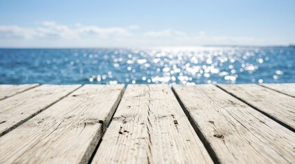 Fototapeta premium Empty wooden pier overlooking the sparkling blue ocean during a sunny summer day