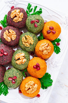 assortment of Pkhali, pumpkin, spinach and beetroot, Georgian dish, on a white plate, appetizer with nuts and spices, no people, homemade,