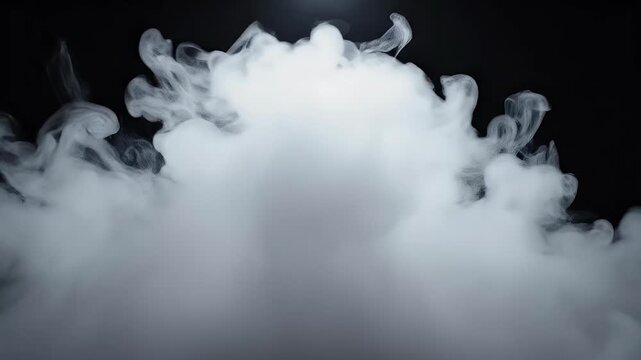 A dramatic low-angle shot captures swirling white smoke against a stark black background, creating an ethereal and mysterious atmosphere.