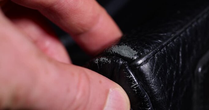   natural black leather bag after prolonged use, details and pieces of natural leather used for the production of items, cover