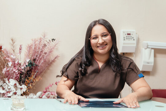 Smiling woman working at a dental health clinic
