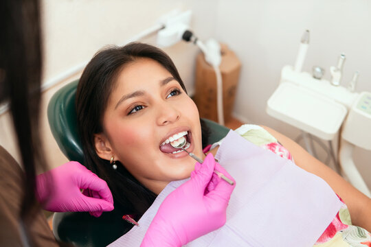 Woman having teeth examined at dentist