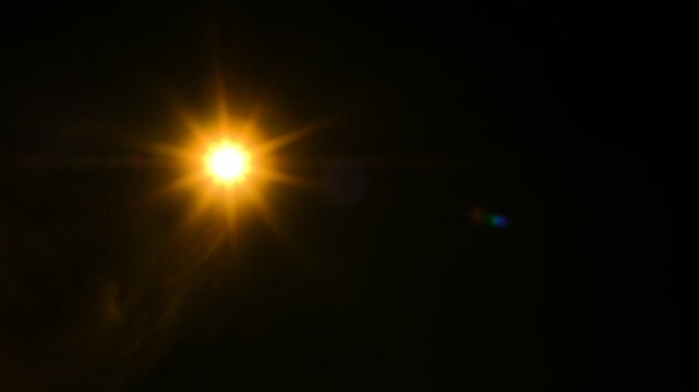 Bright star shines bold against velvet night sky. Lens flare glows with warm, radiant light. Darkness frames star's brilliance, pure and clear. Perfect for cinematic night scenes or cosmic themes