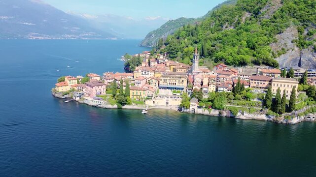 Aerial drone view of Varenna colorful houses on Lake Como coastline, scenic Italian village by water, travel destination Italy
