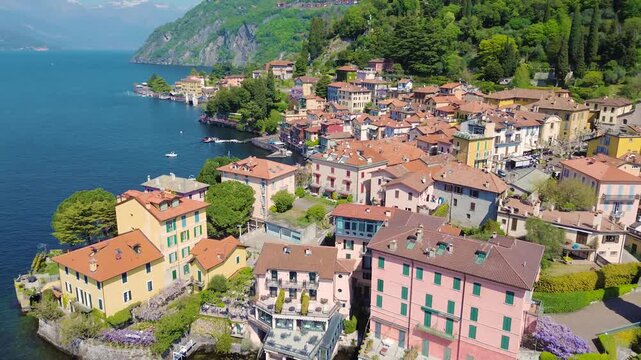 Aerial drone view of Varenna colorful houses on Lake Como coastline, scenic Italian village by water, travel destination Italy