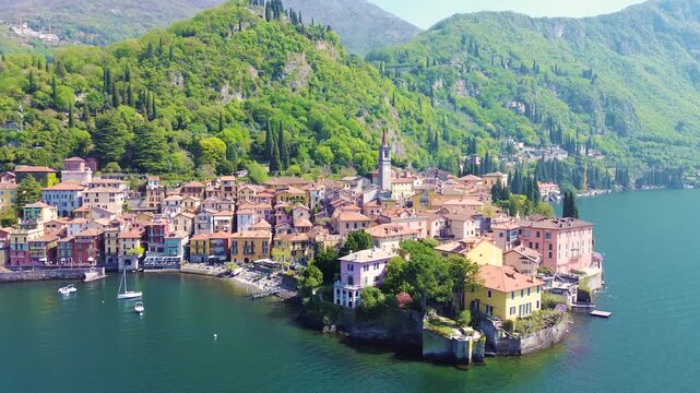 Aerial drone view of Varenna colorful houses on Lake Como coastline, scenic Italian village by water, travel destination Italy