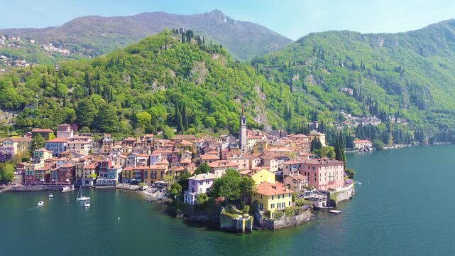 Aerial drone view of Varenna colorful houses on Lake Como coastline, scenic Italian village by water, travel destination Italy