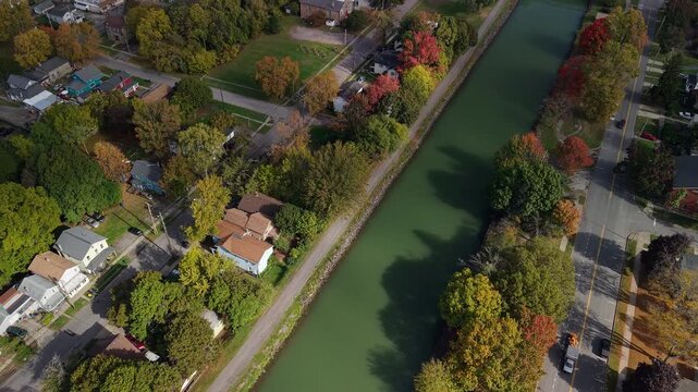 Lockport, New York, USA. Aerial view of Erie Canal running through residential Lockport neighborhood with tree lined banks